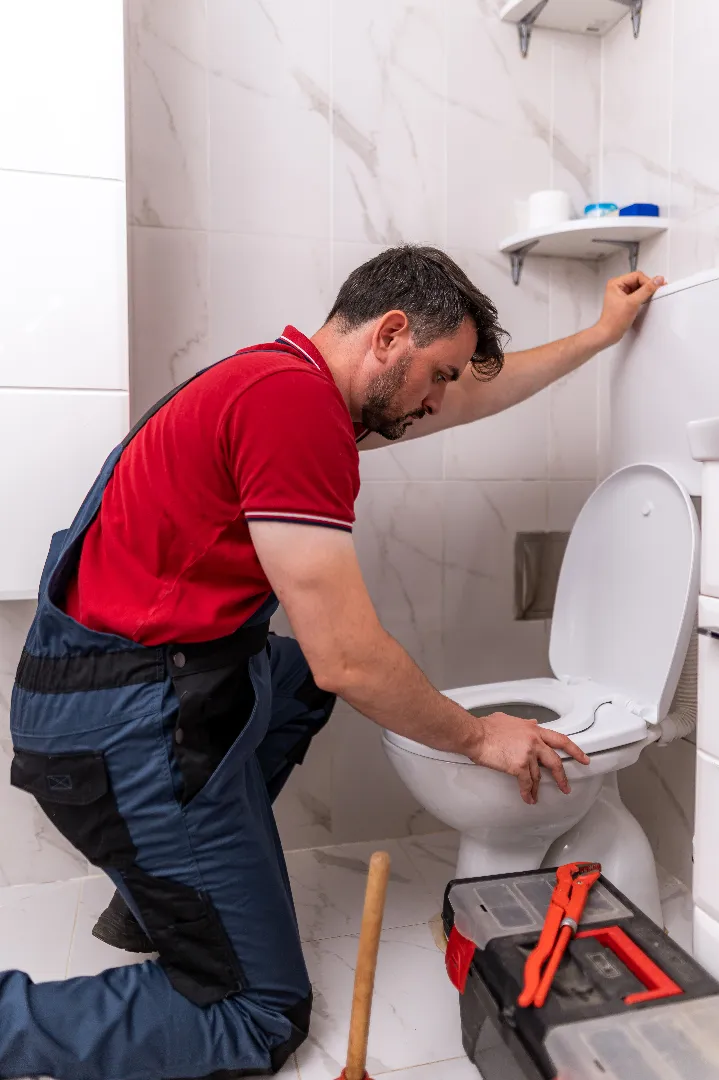 Plumbing repair work being done in modern Milton bathroom — licensed toilet service