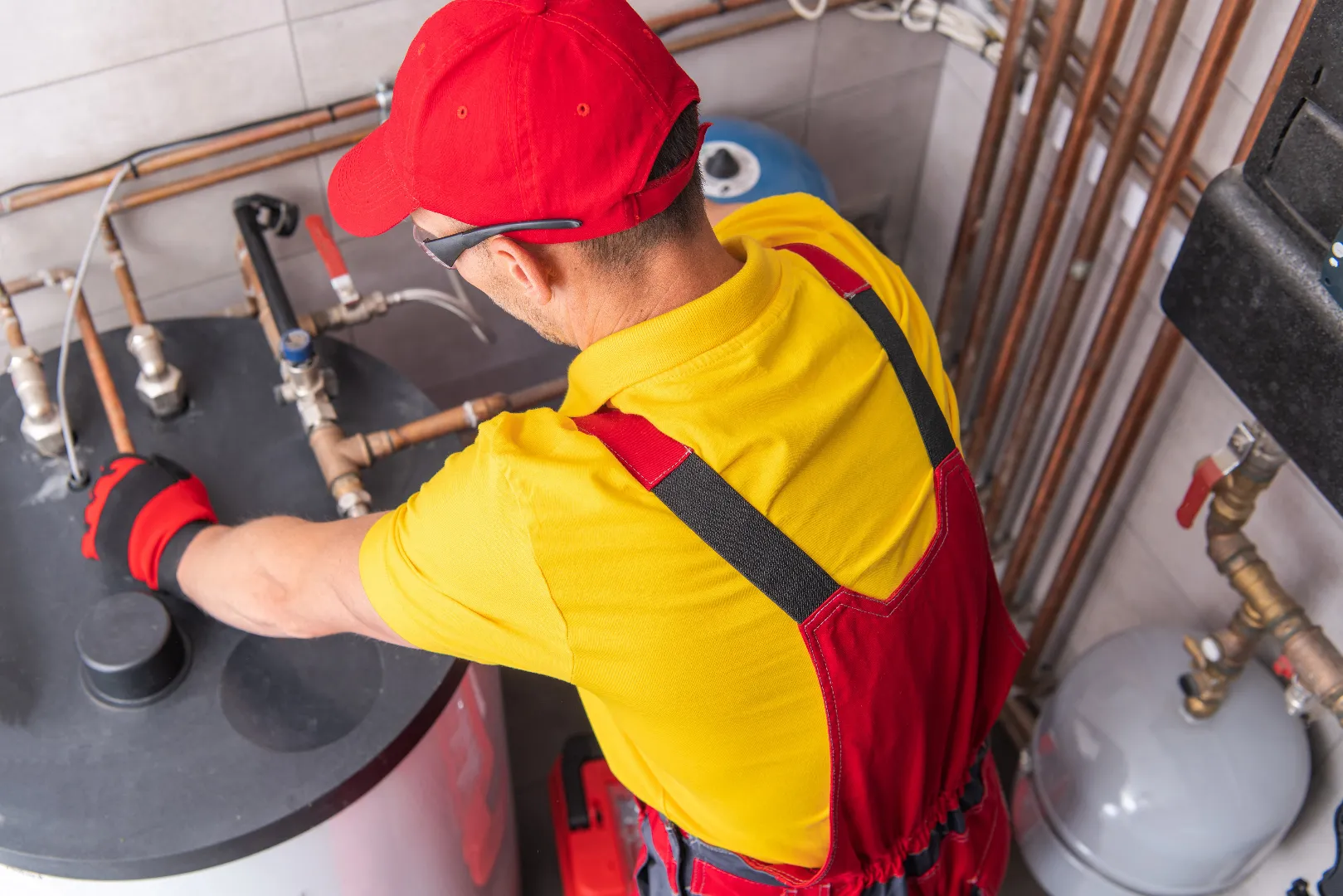 Plumber servicing water heater in Mississauga home — professional repair and replacement