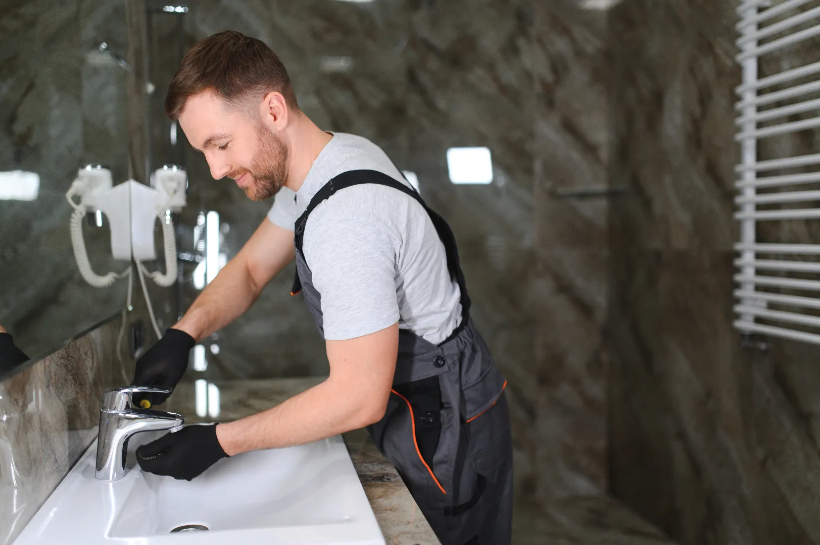 Plumber repairing faucet — Emergency Repair Plumbers serves all GTA cities and communities