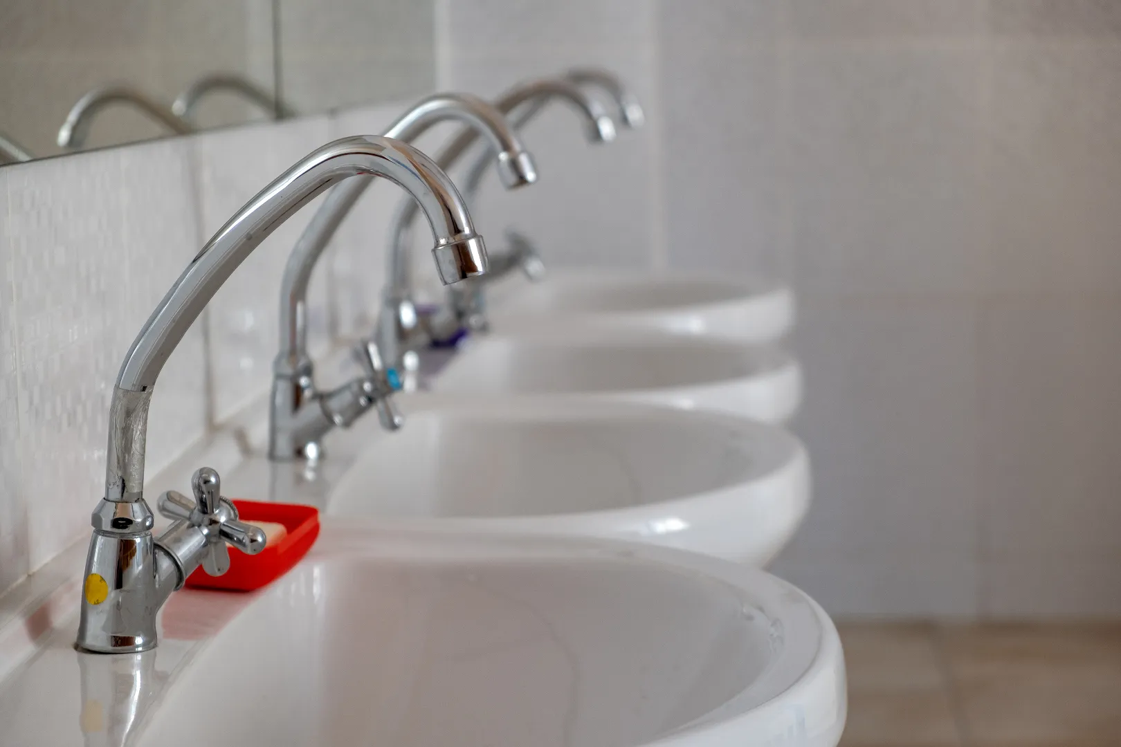 White ceramic commercial washing basins with stainless fittings installed by Toronto commercial plumber
