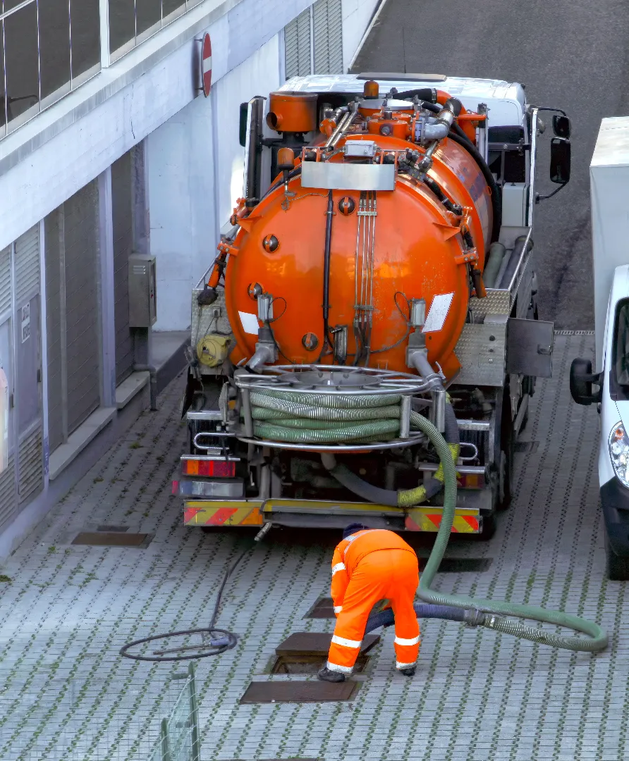 Plumber lowering sewer hose into drain during camera inspection service in Toronto GTA