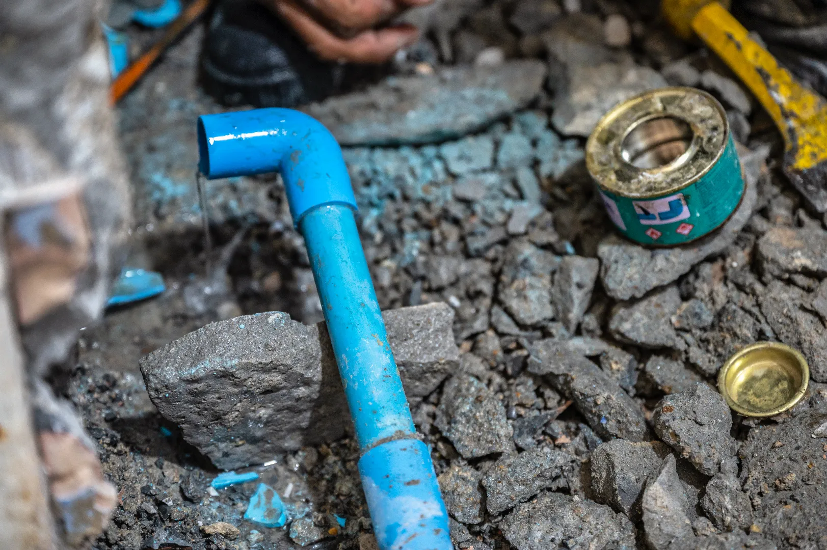 Plumber dismantling and repairing leaking water pipe during emergency water line repair in Toronto